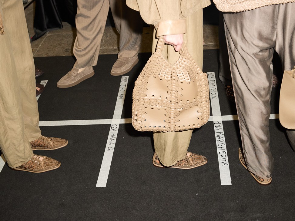 Una invitada sostiene un bolso en el desfile de despedida de Giorgio Armani en la Semana de la Moda de Milán